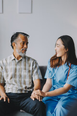 Wall Mural - Doctor holding hands of patient at hospital.