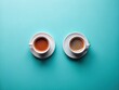 © Oliver - Overhead of Two Cups of Coffee for a Meeting on a Light Blue Table