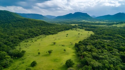 Aufkleber - Aerial View of Lush Green Valley with Mountains Under Dramatic Cloudy Sky : Generative AI