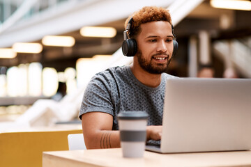 Poster - Man, laptop and headphones with typing at startup for editing, review and listen to sound for project. Person, smile and video editor by computer, audio or music for film production at media company