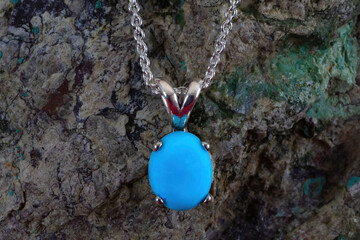 Wall Mural - Mexican turquioise oval cabocon pendant, 10x8mm. Sterling silver setting and chain. Background is raw turquoise in matrix rock.
