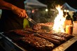 © Muhammad - Delicious burgers and sausages grilling over an open flame at a night market.