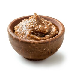 Wall Mural - Tahini, sesame seed butter in a small wooden bowl, garnished with sesame seeds, isolated on white background