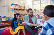 © Rido - Teacher reading a fairy tale to pupil at school library