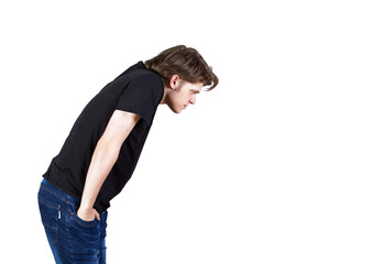 Poster - A man dressed in at-shirt and blue jeans, leaning forward in profile view. Isolated on a white background. Concept of curiosity or focus