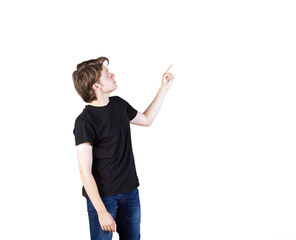 Poster - Young man wearingt-shirt and jeans pointing upward on white background. Isolated concept for advertising, presentation, or template