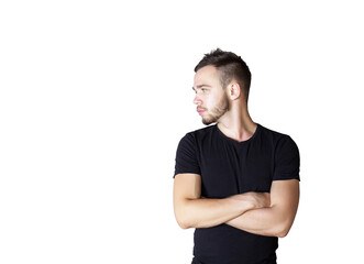 Poster - Young man int-shirt standing with arms crossed, looking to the side on a clean white background. Concept of casual fashion and attitude