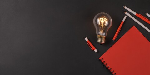 Fototapete - Minimalist Desk Creativity Illuminated Edison Bulb on Matte Black Surface with Red Stationery - Inspiring Modern Workflows in Tech Innovation and Digital Marketing