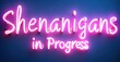 © antishock - Glowing neon letters forming shenanigans in progress pulsing mischievously in bright pink against dark background creating bold contrast playful typography modern illuminated style