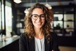 © nsit0108 - Portrait of a young businesswoman wearing eyeglasses and smiling in a modern office