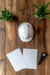Poster - Natural Workspace Aesthetic White Construction Helmet with Blueprints on Rustic Wood Table - Green Project Planning, Renewable Development and Sustainable Design Focus