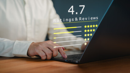Fototapete - Customer types on a laptop with a digital overlay showing a 4.7 star rating and reviews. Business service concept of customer feedback, product evaluation, and user satisfaction in a digital context.