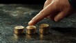 © NCSF - A businessman hand is pointing to stacks of coin