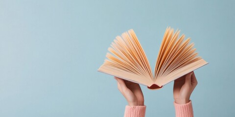Leinwandbilder - Minimalist Open Book Display Against Soft Blue Background - Educational Publishing Concept with Ethereal Light for Knowledge Enhancement and Eco-Friendly Learning Materials