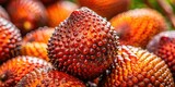 Aerial close-up: glistening salak snake fruit, water droplets clinging to the zalacca skin.