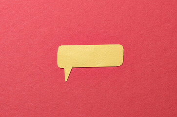 Poster - Yellow cut out blank paper speech bubble of rectangular shape and rounded corners with copy space for text on red background, flat lay top view conceptual backdrop