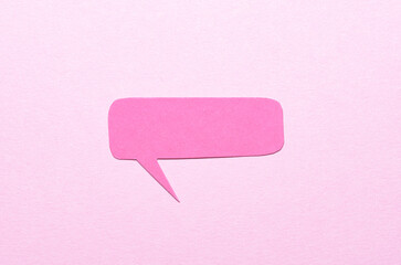 Poster - Cut out blank paper speech bubble of rectangular shape and rounded corners with copy space for text on pink background, flat lay top view conceptual backdrop