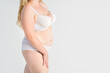 © staras - Fat woman in white underwear on gray background, overweight female, obesity body, weight loss concept with copy space