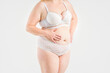 © staras - Fat woman in white underwear on gray background, overweight female, obesity body, weight loss concept
