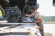 © Serhii - Truck repair service. Mechanic makes computer diagnostic of the semitruck