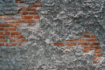 Poster - Close-up of an old wall with exposed brick and crumbling plaster. The texture is rough and aged. Weathered Brick and Plaster Wall Texture Sharp Detail background.
