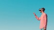 © musa - Man using VR headset outdoors, clear sky background