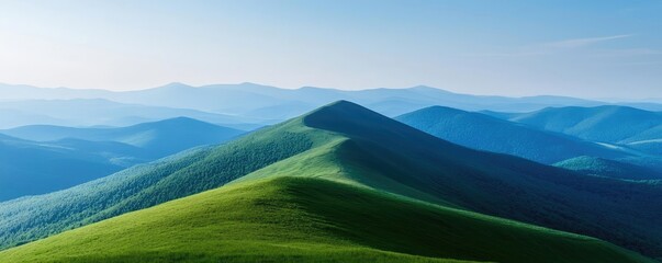 Poster - Mountains landscape nature idea. Breathtaking view of rolling green hills under a clear blue sky on a sunny day.
