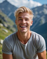 Wall Mural - Summer portrait Caucasian man joyful short blond hair t shirt and shorts mountain background