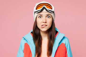 Poster - Close up skier young sad shocked woman she wear warm blue padded jacket ski goggles mask spend extreme weekend winter season in mountains look camera isolated on plain pink background. Hobby concept.