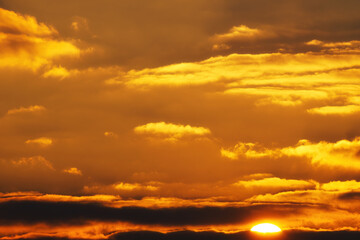 Wall Mural - beautiful and dramatic sunset sky with bright yellow clouds as abstract background