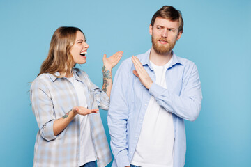 Wall Mural - Young angry sad mad couple two friends family man woman they wear shirt casual clothes together scream shout cry isolated on pastel plain light blue cyan background studio portrait. Lifestyle concept.