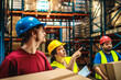 © Davor - Warehouse workers carrying boxes while supervisor giving instructions in storage facility
