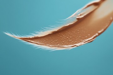 Aufkleber - Close-up image of a single feather resting on a blue surface