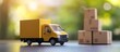 © STwul - Yellow delivery truck model near boxes, outdoors