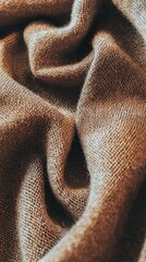 Aufkleber - A close-up view captures the intricate textures of a warm brown fabric, showcasing soft folds and delicate interplay of light and shadow, inviting tactile exploration