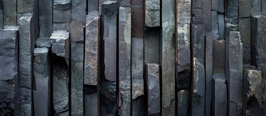 Poster - Textured slate stone wall with vertical rectangular slabs varying in color and thickness suitable for background use. Copy Space