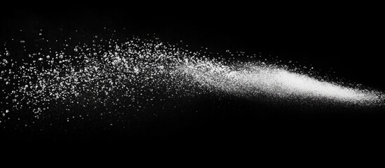 Poster - White powder particles dispersing on black background with dynamic motion effect and ample room for text placement Copy Space