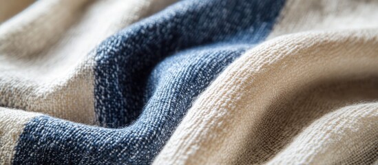 Poster - Close-up of textured fabric with beige and blue stripes showcasing intricate fibers and folds suitable for textile design Copy Space