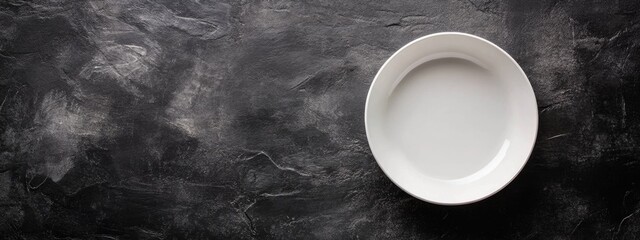 Poster - Empty white plate on dark textured stone background with copy space for design or text placement