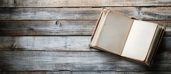 Poster - Open blank book on rustic wooden surface with copy space for text or design elements