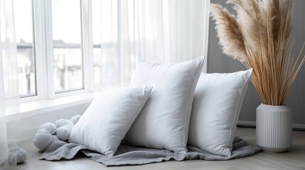 Poster - White Decorative Pillows on Light Grey Blanket Near Large Window in Cozy Modern Interior Setting