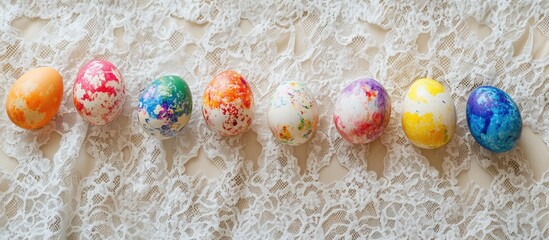 Poster - Colorful dyed Easter eggs arranged in a row on textured lace fabric background.