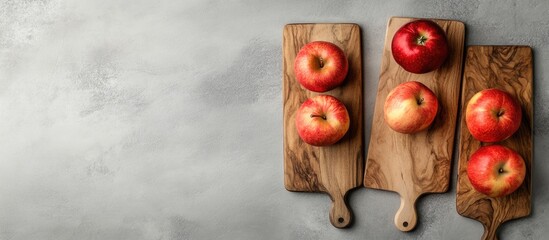 Poster - Ripe Red Apples on Rustic Wooden Boards with Gray Background and Copy Space