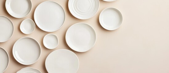 Poster - Assorted Ceramic Plates Arrangement on Beige Background with Copy Space