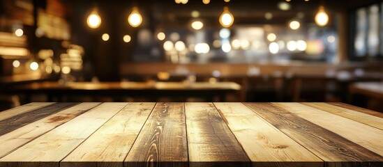 Aufkleber - empty wooden table with blurred restaurant interior and warm lighting in background