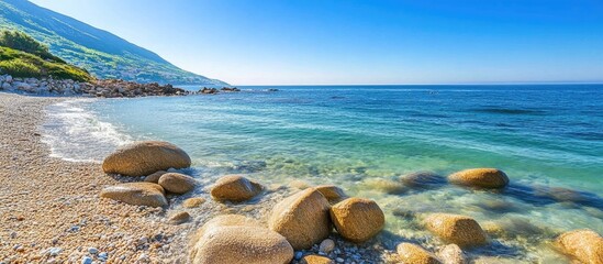 Poster - coastal landscape with rocky beach and clear turquoise water under bright sunny sky in a tranquil na