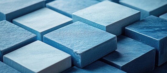 Poster - Blue textured square tiles arranged in a geometric pattern with varying shades of blue Copy Space
