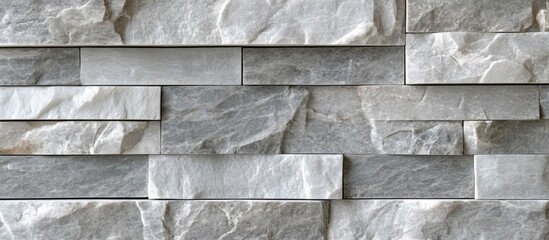 Wall Mural - Textured wall made of varying shades of grey stone tiles arranged in a modern pattern with Copy Space