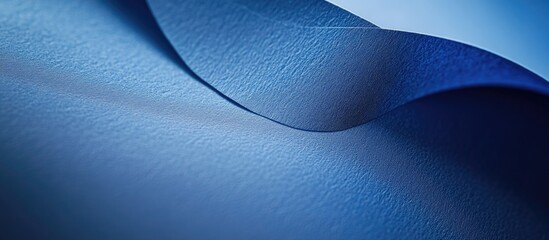 Poster - Blue textured paper with soft curves and folds creating an abstract background Copy Space