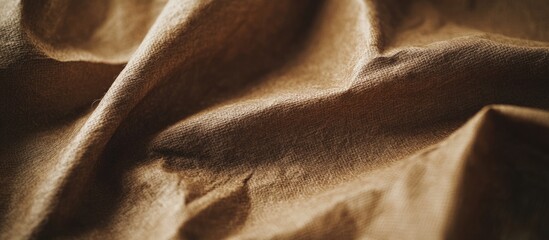 Poster - Brown textured fabric with wrinkles and folds showcasing natural fibers and softness suitable for background use